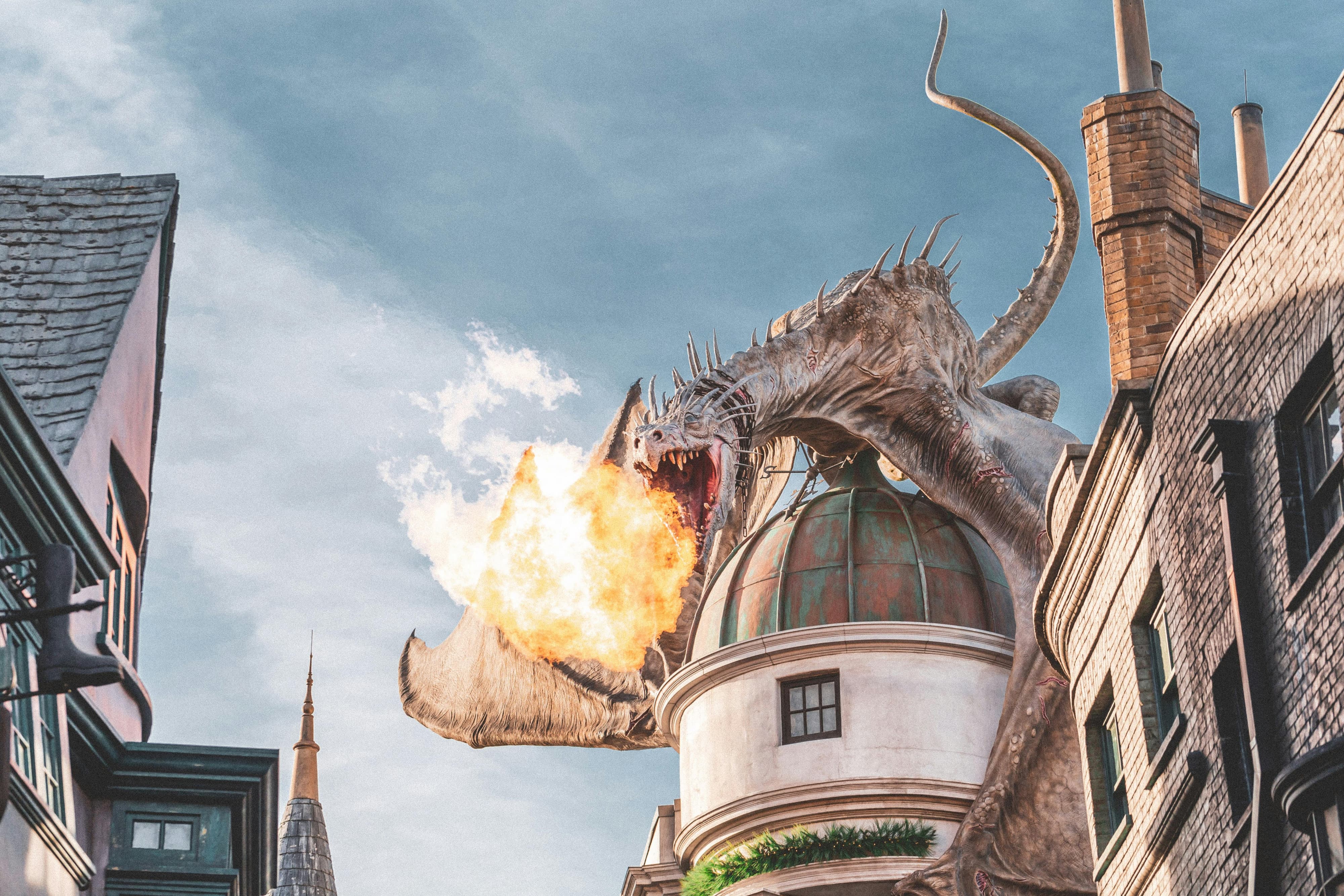 Dragon perched atop a turret, breathing fire.